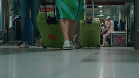 Passengers-with-suitcases-leaving-airport-terminal