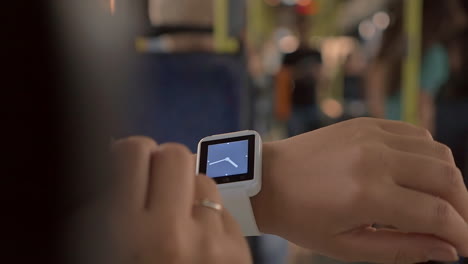 Woman-using-smartwatch-in-the-bus