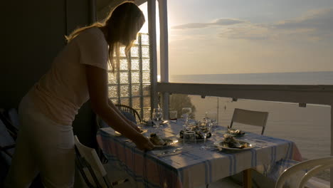 Woman-serving-dinner-on-the-home-balcony