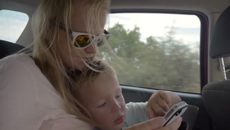 Child-playing-with-mothers-smartphone-in-the-car