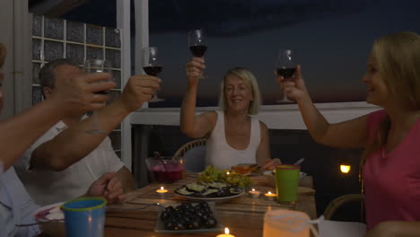 People-enjoying-food-and-wine-during-home-dinner