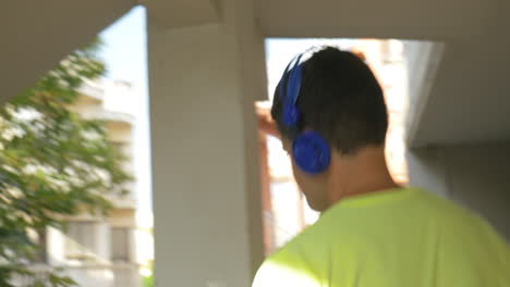 Man-in-headphones-walking-downstairs
