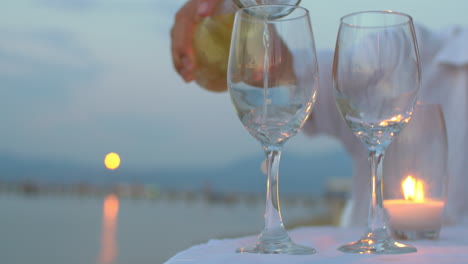 Pouring-wine-in-glasses-at-seaside
