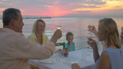Family-dinner-by-the-sea-at-sunset