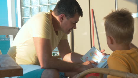 Father-reading-a-book-to-little-son