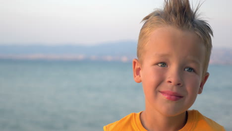 Little-blond-child-on-sea-background