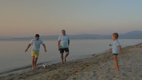 Family-football-team-playing-at-the-seaside