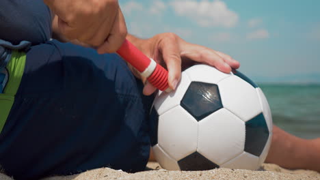 Man-pumping-a-football-on-the-shore