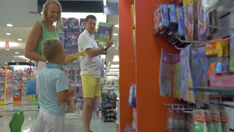 Mother-father-and-son-in-toy-shop