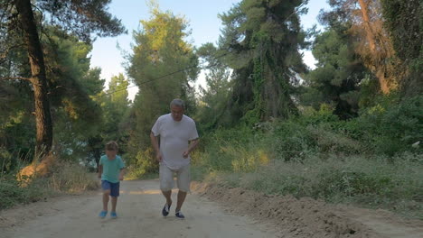 Grandfather-and-grandson-jogging-in-the-forest