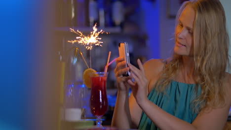 Woman-making-selfie-with-cocktail-and-sparkler