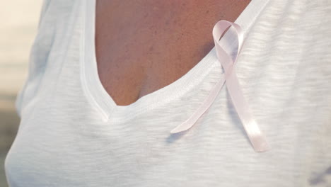 Senior-woman-wearing-pink-awareness-ribbon