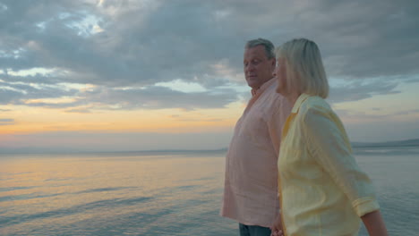 Loving-senior-couple-enjoying-walk-at-the-seaside