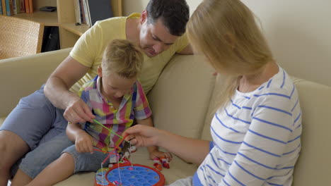 Parents-and-child-playing-fishing-game-at-home