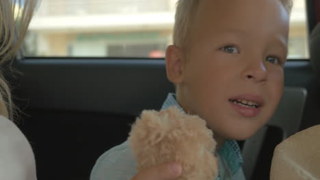 Boy-with-Plush-Toy-on-the-Car-Back-Seat