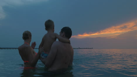 Young-family-enjoying-sea-bathing-in-the-evening