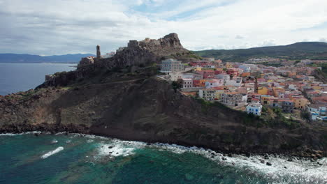 city-of-Castelsardo,-Certeña:-aerial-view-in-orbit-over-this-impressive-city-built-on-a-mountain-and-with-its-colorful-houses-and-its-historic-tower