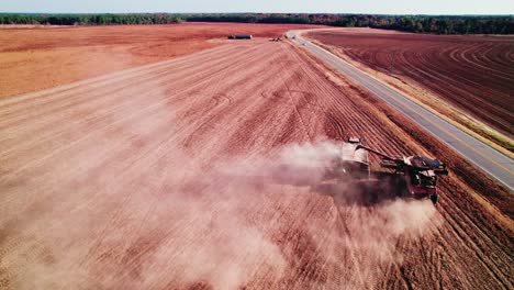 Drone-view-of-combine-harvester-transferring-non-GMO-soybeans-to-another-trailer-tractor
