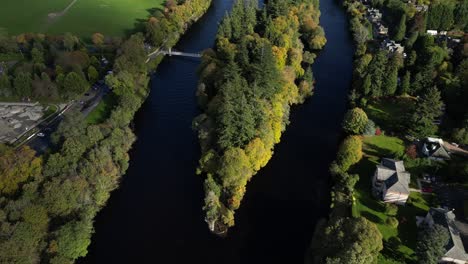 aerial-drone-footage-of-small-islands-on-Ness-river-in-Inverness,-Scotland-in-the-Highlands