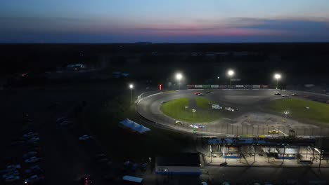 Flat-Rock-Speedway-during-race-event-at-night,-aerial-view