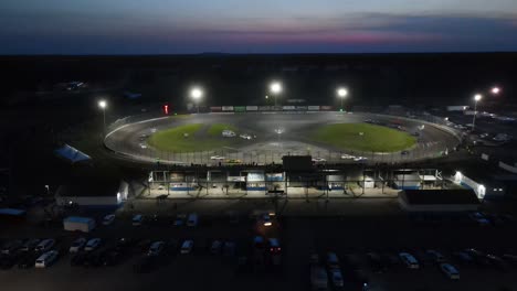 Lit-track-at-night-during-race-event,-aerial-drone-view