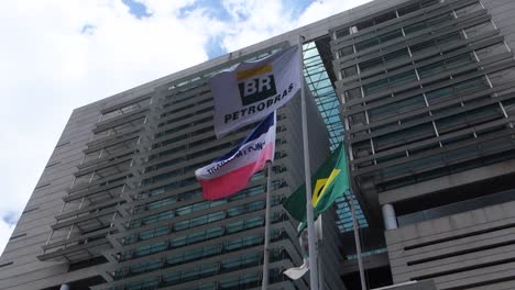low-angle-of-flags-waving-in-front-of-Petrobras-building-in-Vitoria,-Espirito-Santo