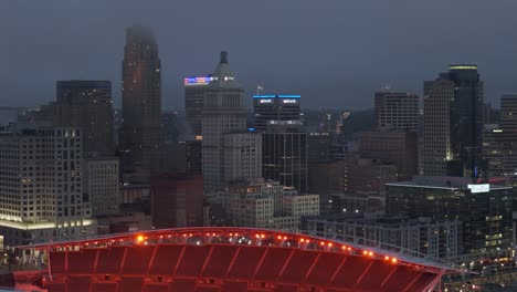 Aerial-of-Paycor-Stadium-overlooking-US-city-Cincinnati-at-night,-Pan-right