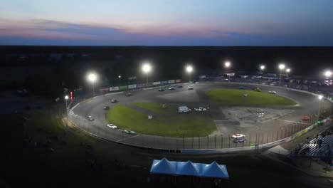 Cars-racing-at-night-in-small-circuit,-aerial-view