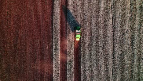 epic-top-down-aerial-of-a-green-combine-harvester-collecting-cotton,-showcasing-modern-agriculture