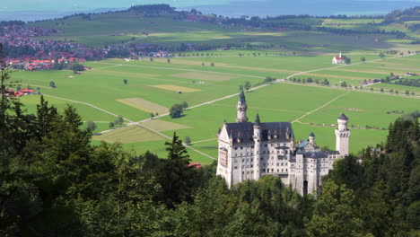 Neuschwanstein-Castle-in-Schwangau,-Germany-overlooking-valley-near-the-Alps