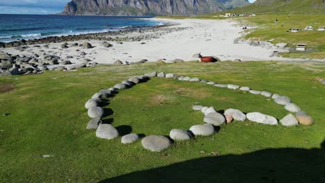 Uttakleiv-Beach-and-Stone-Heart-at-Lofoten-Islands-in-Norway,-Scandinavia---Tilting-Up