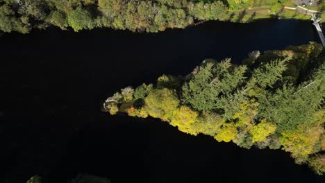 aerial-drone-footage-of-small-islands-on-Ness-river-in-Inverness,-Scotland-in-the-Highlands