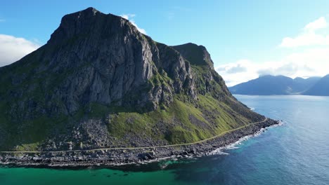 Rocky-Island-and-Blue-Sea-at-Lofoten-Islands-in-Norway,-Scandinavia---Aerial-Circling