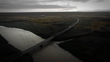 Aerial-ring-road-Iceland,-car-driving-over-bridge-and-river,-flying-over-nature-mountain-cinematic-view