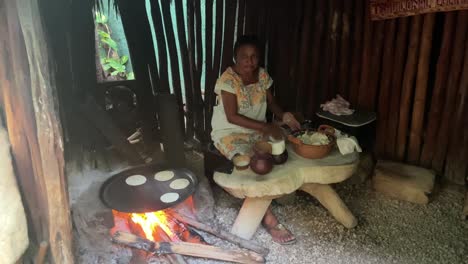 old-Mexican-Maya-woman-cooking-tortillas-in-traditional-kitchen-with-fire