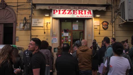 Customers-standing-in-front-of-Famous-Pizzeria-Da-Michele-Chain,-considered-as-the-first-pizzeria's-in-the-world