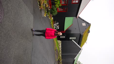 Woman-walking-in-Torshavn-old-town-called-Reyn,-Faroe-Islands