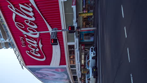 Huge-Coca-Cola-billboard-in-Sydney,-Australia-intersection
