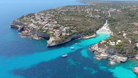 Mallorca:-Aerial-View-Of-Resort-Town-Cala-Liombards-On-Majorca-Island,-Spain,-Europe-|-Ships-at-Beachfront