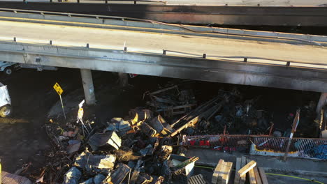 Aerial-view-around-burnt-pallets-under-the-damaged-Interstate-10-in-Los-Angeles