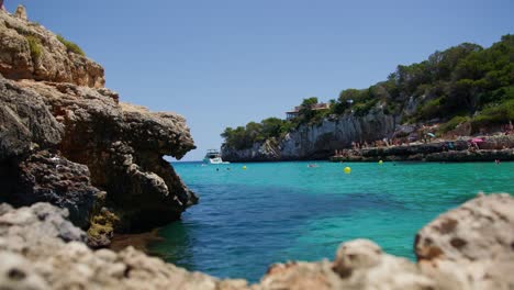 Mallorca:-Beach-Side-View-Of-Resort-In-Cala-Liombards-On-Majorca-Island,-Spain,-Europe-|-Women-On-Cliff