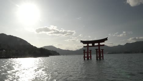 Itsukushima-Jinja-Otorii-Floating-In-Water-With-High-Sun-In-The-Sky-In-Miyajima