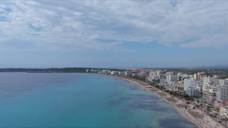 Mallorca:-Aerial-View-Of-Resort-Town-Son-Servera-On-Majorca-Island,-Spain,-Europe-|-Beach-Crowd-Follow
