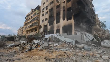 Aftermath-of-destroyed-city-Gaza-after-airstrike,-missile-attack-during-Israel-Hamas-War-2023,-Military-vehicle-driving-through-the-bombarded-streets-of-Gaza