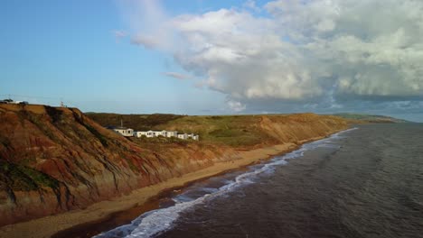 Aerial-Drone-footage-along-coast-of-the-Isle-of-Wight-at-the-Buddle-Brock-with-the-cliffs-down-to-the-beach