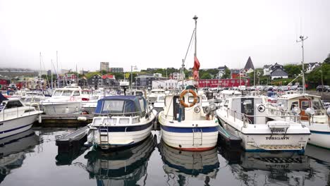Boats-docked-in-Vagsbotnur,-maritime-pier-of-Torshavn,-Faroe-Islands
