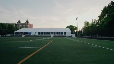 Dolly-shot-right-left:-Event-Tent-on-Urban-Football-Field,-Chicago-USA