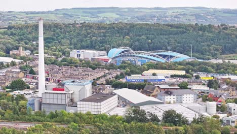 Huddersfield-England-football-stadium,-suburb,-and-industrial-factories,-aerial
