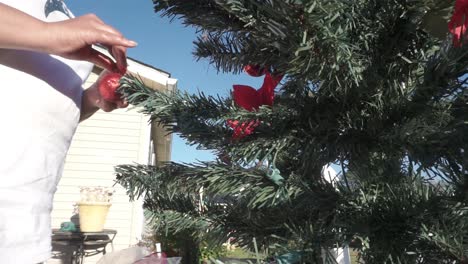Black-female-hands-decorating-Christmas-tree