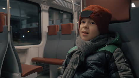 Boy-traveling-by-suburban-train